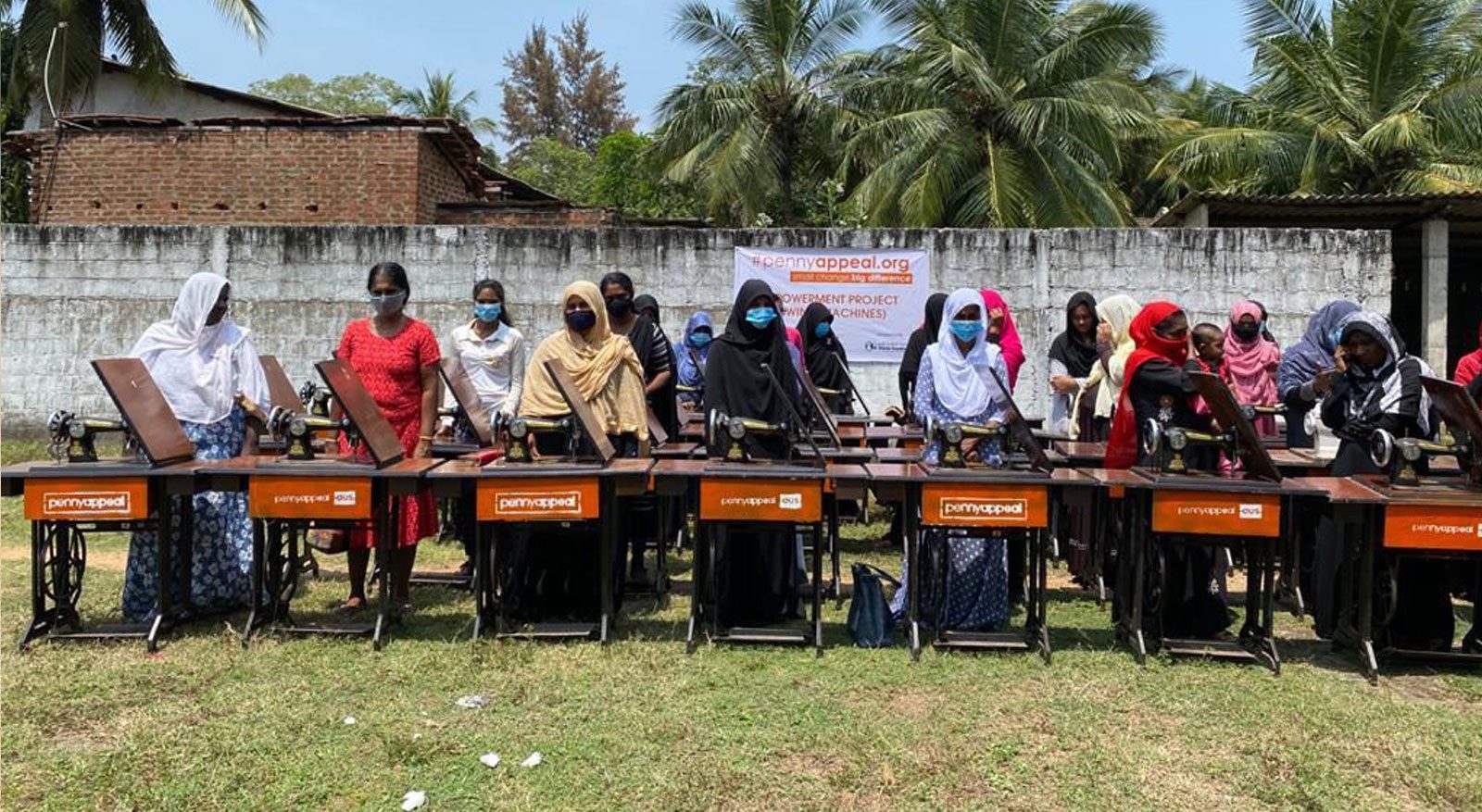 Women receiving sewing machines as part of a livelihood programme
